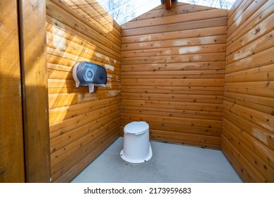 Interior of wooden public lavatory in the Jasper National Park, Alberta, Canada. Countryside toilet concept.