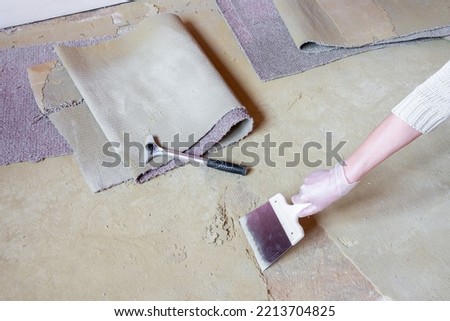Interior work, peeling off the old carpet. Remove glue and residue from the floor.