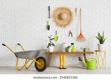 Interior of workshop with bench, straw hat and gardening tools - Powered by Shutterstock