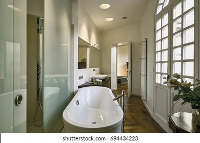 Interiors Shots Of A Classic Bathroom With Wooden Flooring In Foreground The Bathtub And Masonry Shower Cubicle With Glass Sliding Door On The Bottom The Bedroom
