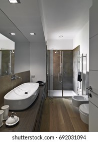 Interiors Shots Of A Modern Bathroom Whose Floor Is Made Of Wood  In Foreground The Counter Top Washbasin On The Wood Furniture In The Bottom The Masonry Shower Cubicle With Glass Door 