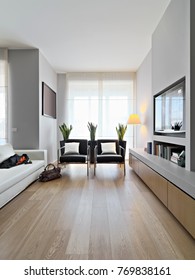 Interiors Shots Of A Modern Living Room In The Foreground Two Leather Armchairs And Leather Sofa The Floor Is Made Of Wood