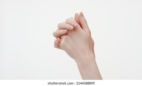 Interlocked female hands on white background, close-up shot | Hand care concept