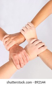 Interlocked hands of four people