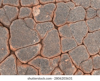 Interlocking Flat Red Granite Stones Separated By Deep Cracks Flat Lay Creating An Organic Mosaic Pattern With Copy Space