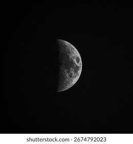 Intermediate moon phase called half moon isolated on black sky background