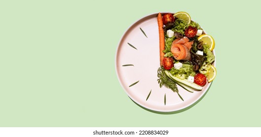 intermittent fasting concept clock dish with vegetables and salmon, fish, salad - Shutterstock ID 2208834029