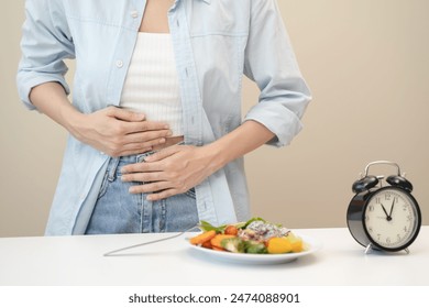 Intermittent fasting concept, Close-up on clock and people feeling hungry waiting time to eat during intermittent fasting diet session