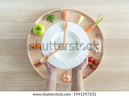 Intermittent fasting IF diet concept with 8-hour clock timer for eating nutritional or keto low carb, high fat and protien food meal healthy dish and 16-hour skipping meal for weight loss