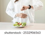 Intermittent fasting, diet healthy asian young woman dietary watching wrist watch, stomach ache, temptation hungry of brunch food in morning, waiting time to eat salad but not yet time first meal.