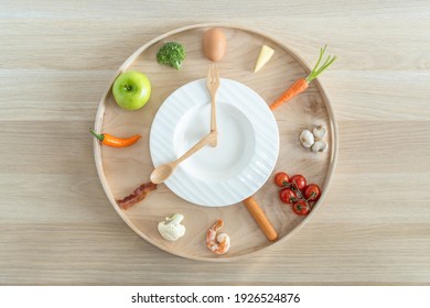 Intermittent fasting IF and ketogenic diet concept with 8-hour clock timer for eating nutritional or keto LCHF low carb high fat food meal healthy dish and 16-hour skipping meal for weight loss - Shutterstock ID 1926524876