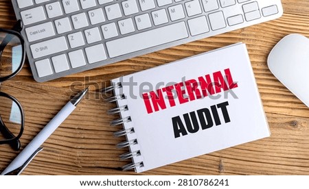 Internal audit concept with notebook on office desk beside keyboard mouse eyeglasses and pen representing corporate. 