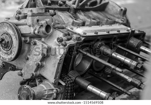 Internal combustion engine of an old car without a\
cylinder head. View from the piston group side. Close-up. Black and\
white photo