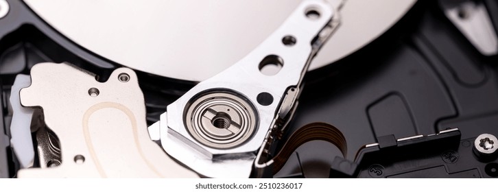 Internal components of an open hard disk drive showing read-write head and platters. Panoramic shot. - Powered by Shutterstock