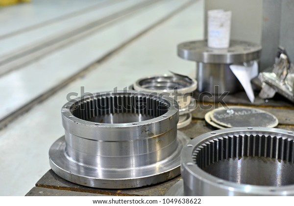 The internal gear\
after machining on the lathe and CNC milling machine lies on a\
wooden rack in the shop.