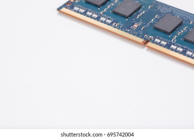 Internal laptop computer memory chip or circuit board lying diagonally across the corner on white with copy space