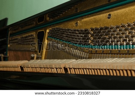 Internal parts of an old piano close-up - mechanics, strings. Selective focus. Details of a musical instrument from the inside