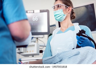 Internal specialist doctor operating endoscope in colonoscopy procedure