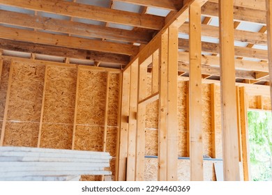 The internal structure of a block wooden house consists of wooden bars treated with an antiseptic and insulation. The parts are fastened on a wooden frame. - Shutterstock ID 2294460369