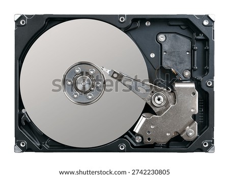 Internal structure of a hard disk drive, HDD, after lifting its lid. Main components are platters that store data, spindle motor, and actuator arm with read and write heads. Isolated from above. Photo