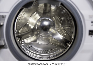 Internal view on empty washing machine. Glass door of a washing machine.