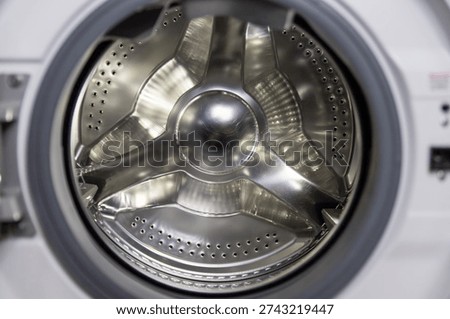 Internal view on empty washing machine. Glass door of a washing machine.