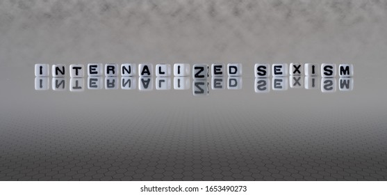 Internalized Sexism Concept Represented By Black And White Letter Cubes