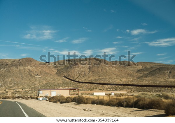 International border fence dividing USA and\
Mexico in Southern California, San Diego\
County