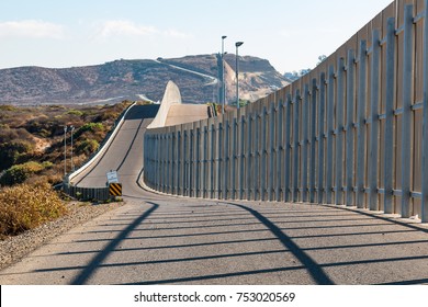 The international border wall between San Diego, California and Tijuana, Mexico, as it begins its journey from the Pacific coast and travels over nearby hills.   - Shutterstock ID 753020569