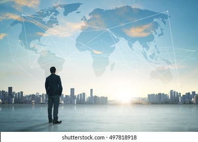 International business concept with businessman on city skyline background with network on map and sunlight