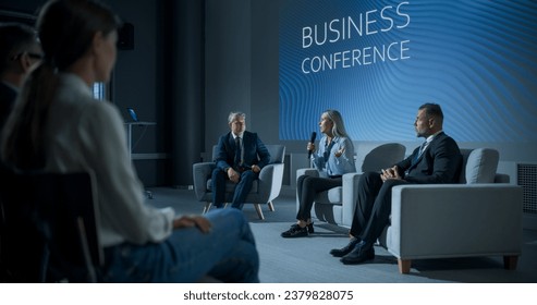 International Business Conference: Caucasian Female Tech CEO Talking With Male Host In Front Of Audience Of Diverse Attendees. Successful Woman Delivering Inspirational Speech For Women In Leadership. - Powered by Shutterstock