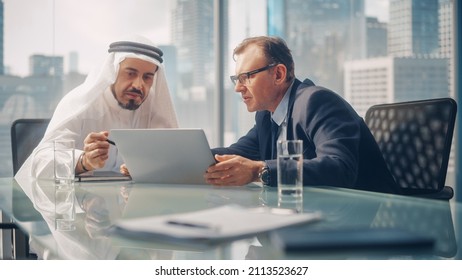 International Business Consultant Advices On Diversification Of Investment Portfolio To Successful Arab Company Owner. Multicultural Meeting In Modern Office Between American And Emirati Businessman.