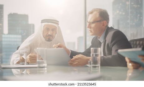 International Business Consultant Advices On Diversification Of Investment Portfolio To Successful Arab Company Owner. Multicultural Meeting In Modern Office Between European And Emirati Businessman.