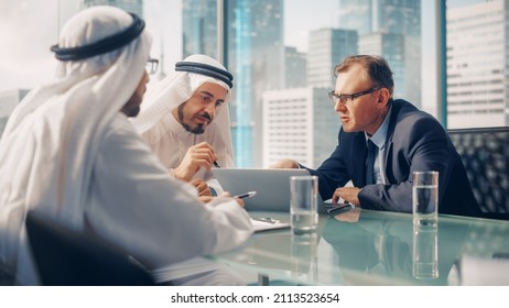 International Business Consultant Advices On Diversification Of Investment Portfolio To Successful Arab Company Owners. Multicultural Meeting In Modern Office Between European And Emirati Businessman