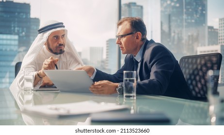 International Business Consultant Advices On Diversification Of Investment Portfolio To Successful Arab Company Owner. Multicultural Meeting In Modern Office Between American And Emirati Businessman.