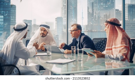 International Business Consultant Advices On Diversification Of Investment Portfolio To Successful Arab Company Owners. Multicultural Meeting In Modern Office Between American And Emirati Businessman