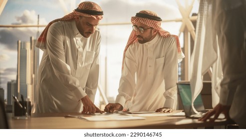 International Business Consultant Advises Arab Company Owners on Financial Growth Strategy Plan. Middle Eastern Meeting in Modern Office Between Successful Muslim Businessmen - Powered by Shutterstock