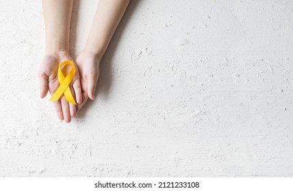 International Childhood Cancer Day. Baby Holding Yellow Ribbon. Sarcoma Awareness, Bladder Cancer. Leukemia Cancer Awareness. World Multiple Sclerosis Day. I Am And I Will. Banner. Copy Space