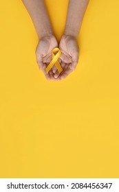 International Childhood Cancer Day. Child Hands Holding Yellow Gold Ribbon. Sarcoma Awareness, Bone Cancer, Childhood Cancer Awareness. Concept I Am And I Will. Banner. Copy Space