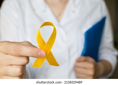 International Childhood Cancer Day. Female Doctor In White Coat Holds Yellow Ribbon. Sarcoma Awareness, Bladder Cancer. Leukemia Cancer Awareness. World Multiple Sclerosis Day.