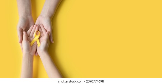 International Childhood Cancer Day. Mom and baby holding yellow ribbon. Sarcoma Awareness, bladder cancer, childhood cancer awareness. Concept I Am and I Will. copy space - Shutterstock ID 2090774698