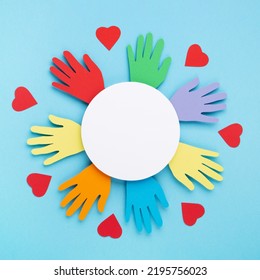 International Day Of Charity, 5 September. Tolerance, Kindness, Cooperative, Friendship, Charity, Humanitarian Aid Day Concept. Colorful Hands On Blue Background, Copy Space, Top View.