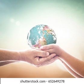 International Day Of Peace Concept: Children Hands Holding Earth Global Over Blurred Abstract Nature Background. Elements Of This Image Furnished By NASA