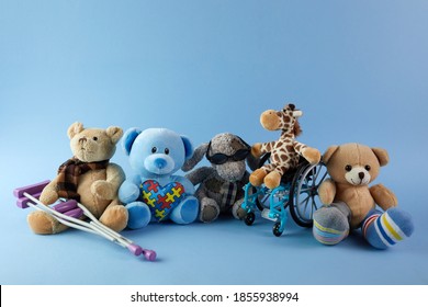 International day of persons with disabilities. Wheelchair with toys sign of different disabilities on blue background. - Shutterstock ID 1855938994