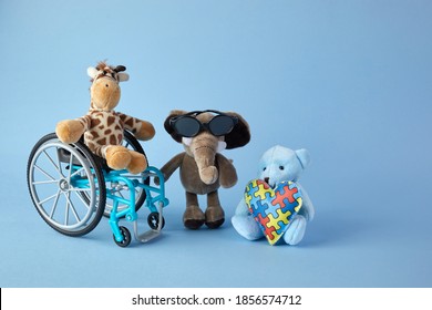 International Day Of Persons With Disabilities. Wheelchair With Toys Sign Of Different Disabilities On Blue Background.