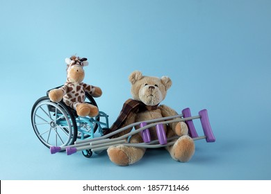 International Day Of Persons With Disabilities. Wheelchair With Toys Sign Of Different Disabilities On Blue Background.