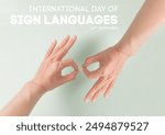 International Day Of Sign Languages concept with human hands making symbol "Connect" on pale green background