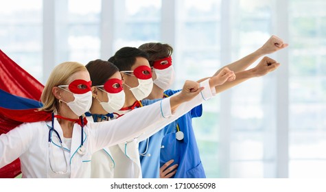 International Doctor And Nurse Team Wearing Surgical Face Mask In Superhero Cape. Medical Staff During Coronavirus Outbreak. Super Hero Power For Clinic And Hospital Personal. Covid-19 Pandemic.