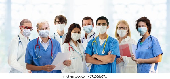 International doctor team. Hospital medical staff. Mixed race Asian and Caucasian doctor and nurse meeting. Clinic personnel wearing face mask and stethoscope. Coronavirus outbreak.
