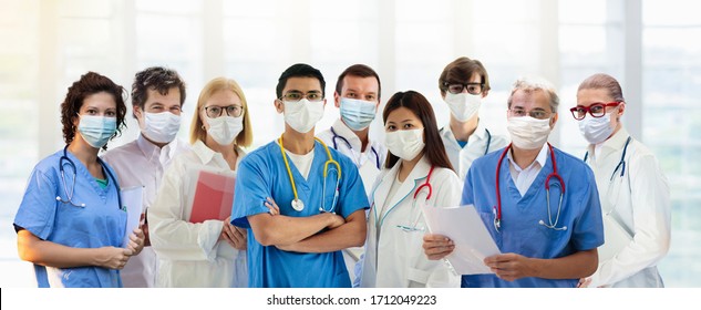International doctor team. Hospital medical staff. Mixed race Asian and Caucasian doctor and nurse meeting. Clinic personnel wearing face mask and stethoscope. Coronavirus outbreak.